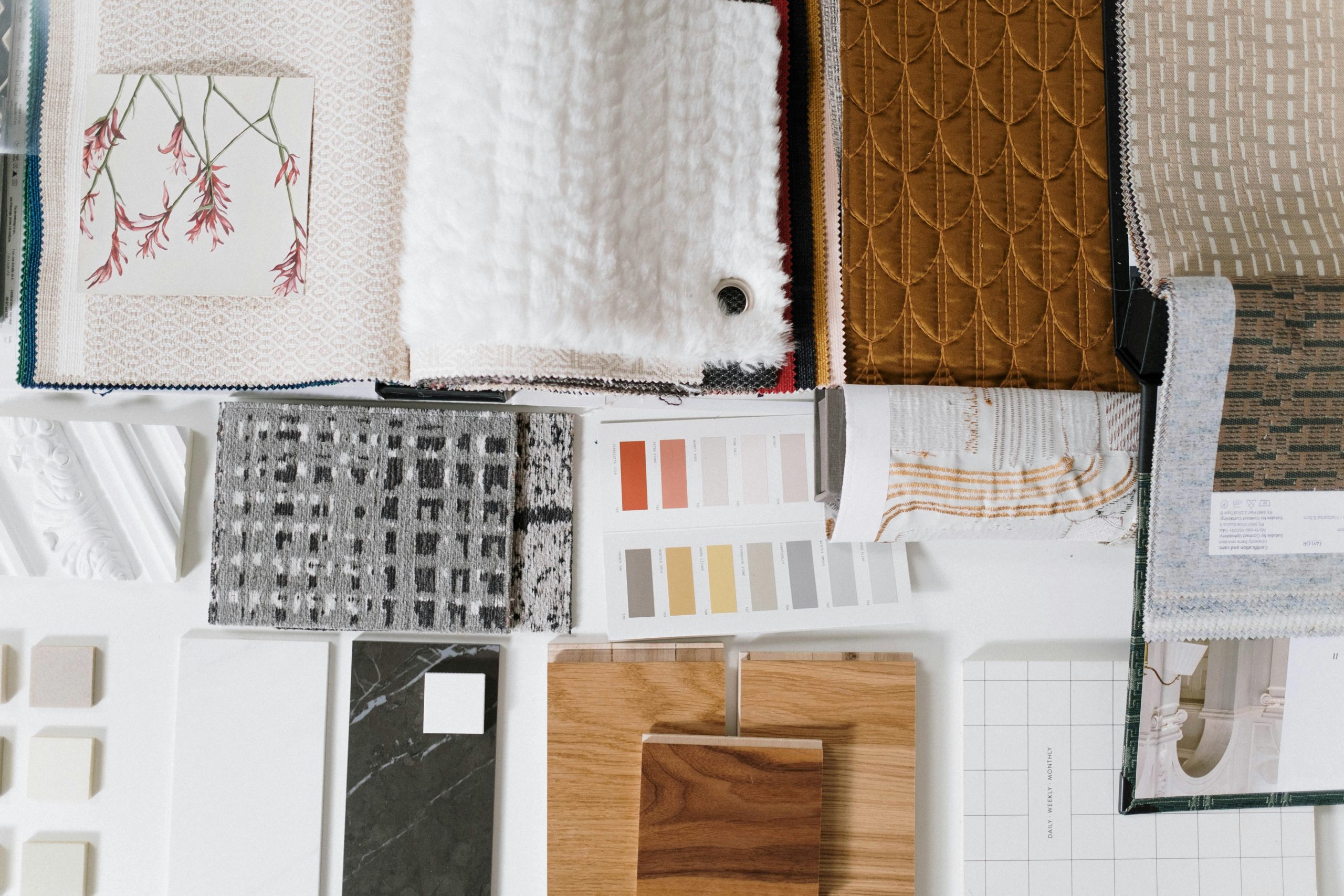 Assorted fabric and textile samples with color swatches for design inspiration.